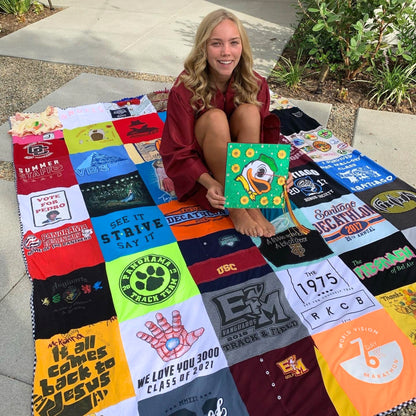 College grad on custom quilt made of t-shirts