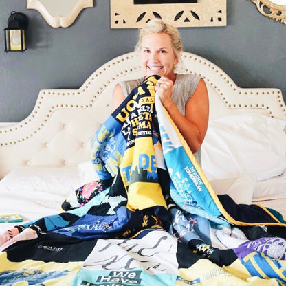 Woman holding memory blanket quilt made out of t-shirts